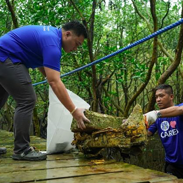 SM City Bataan employee-volunteers clean coastal barangays by the Balanga Wetland and Nature Park.