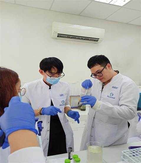 Rebosura (right) of the DOST's Balik Scientist Program is shown mentoring Maynilad employees on biosolids characterization techniques. These lab-scale activities aim to help Maynilad better understand biosolids, with the goal of converting them into valuable resources like energy and nutrients.