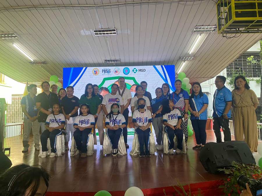 Pupils from Pinagbuhatan, Pasig receive their first dose of the HPV vaccine during the ceremonial vaccination flanked by stakeholders from the education and health departments, and partners from the private sector.