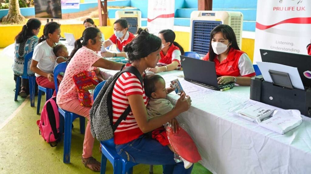 Mothers receiving the FREE PRUMedCare — Select Infectious Disease coverage vouchers for their babies for  the PRUBabiescampaign.