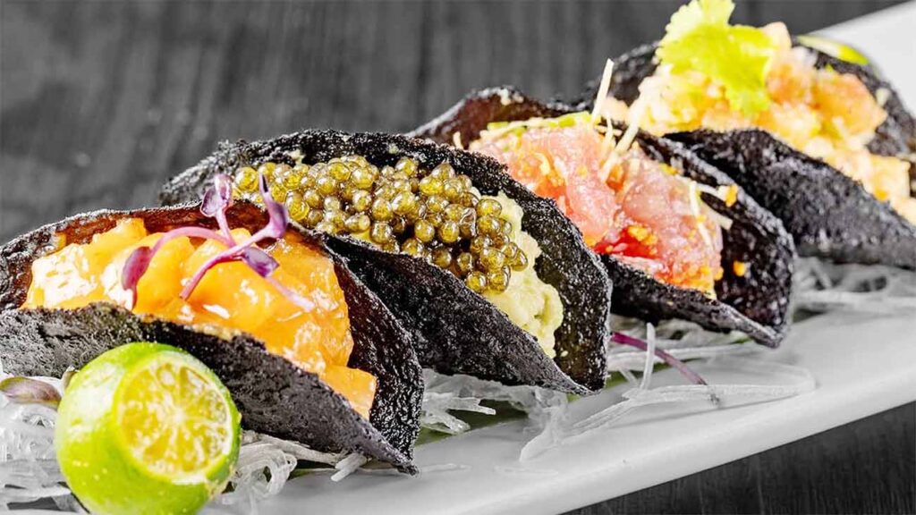 The eye-catching Nobu Nori Tacos are built in seaweed shells, generously stuffed with salmon, tuna, lobster, and avocado topped with caviar.
